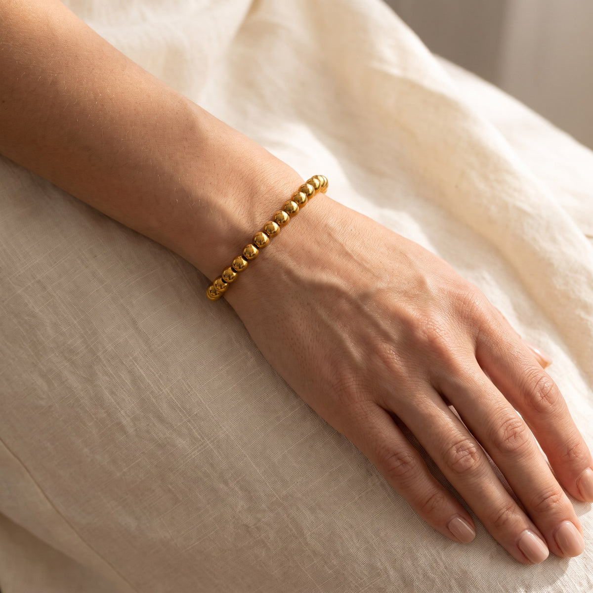Caicos Beaded Bracelet in gold worn on the wrist