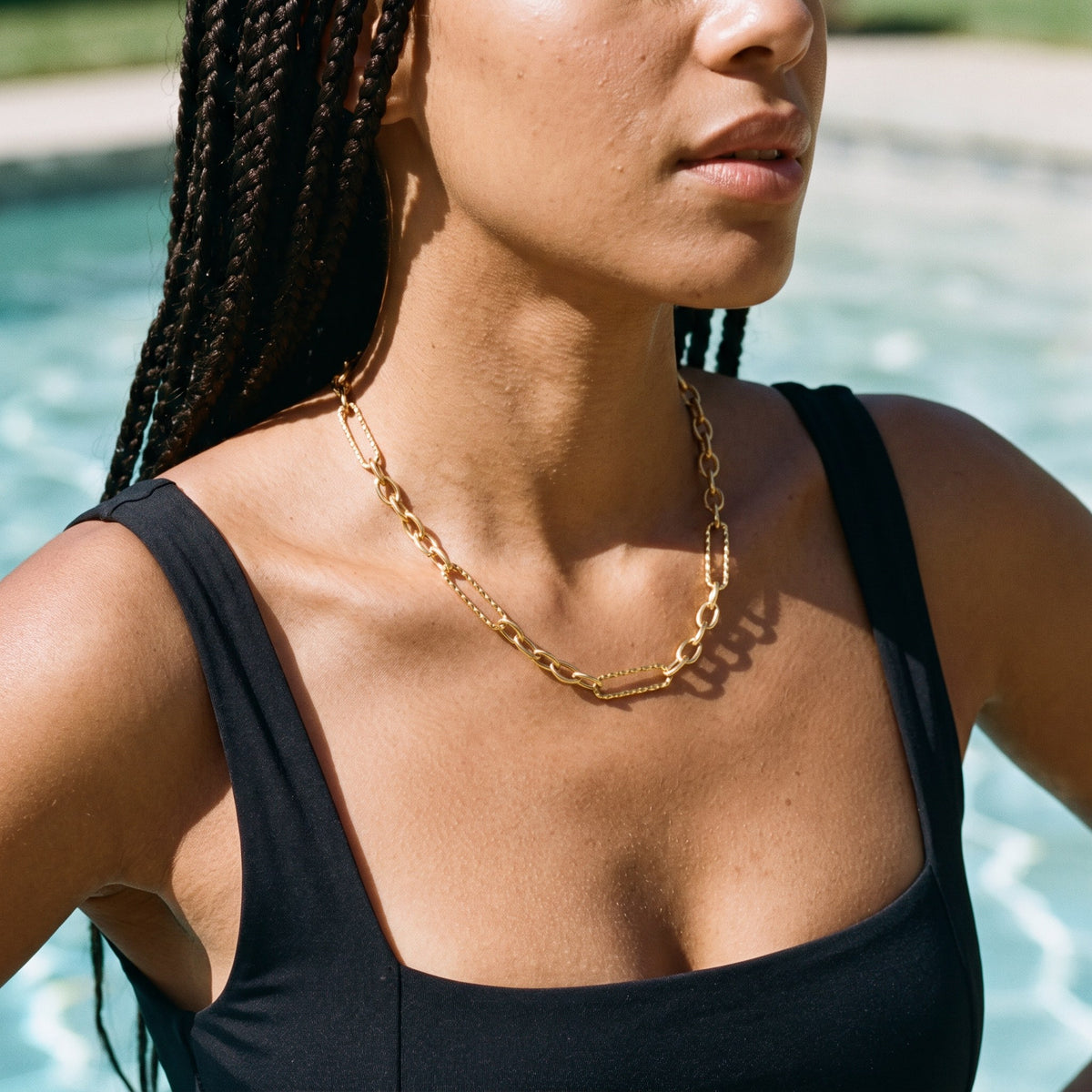 Woman wearing the Dubai Hills chain necklace by the pool