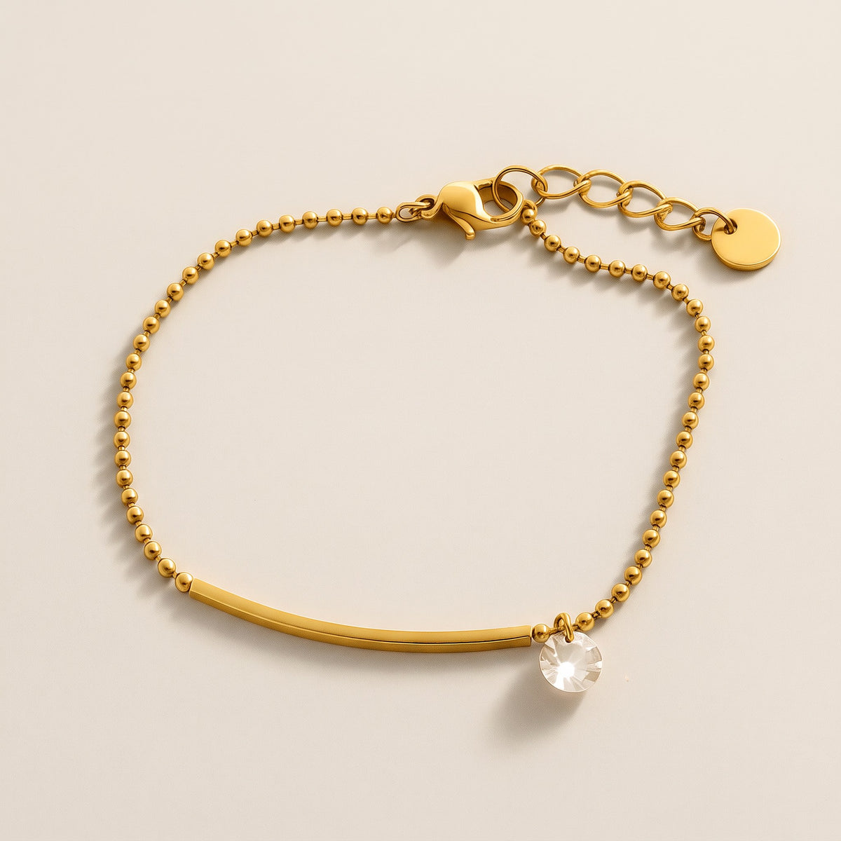 Eos Bracelet in gold, ball chain with a slim bar and one clear crystal