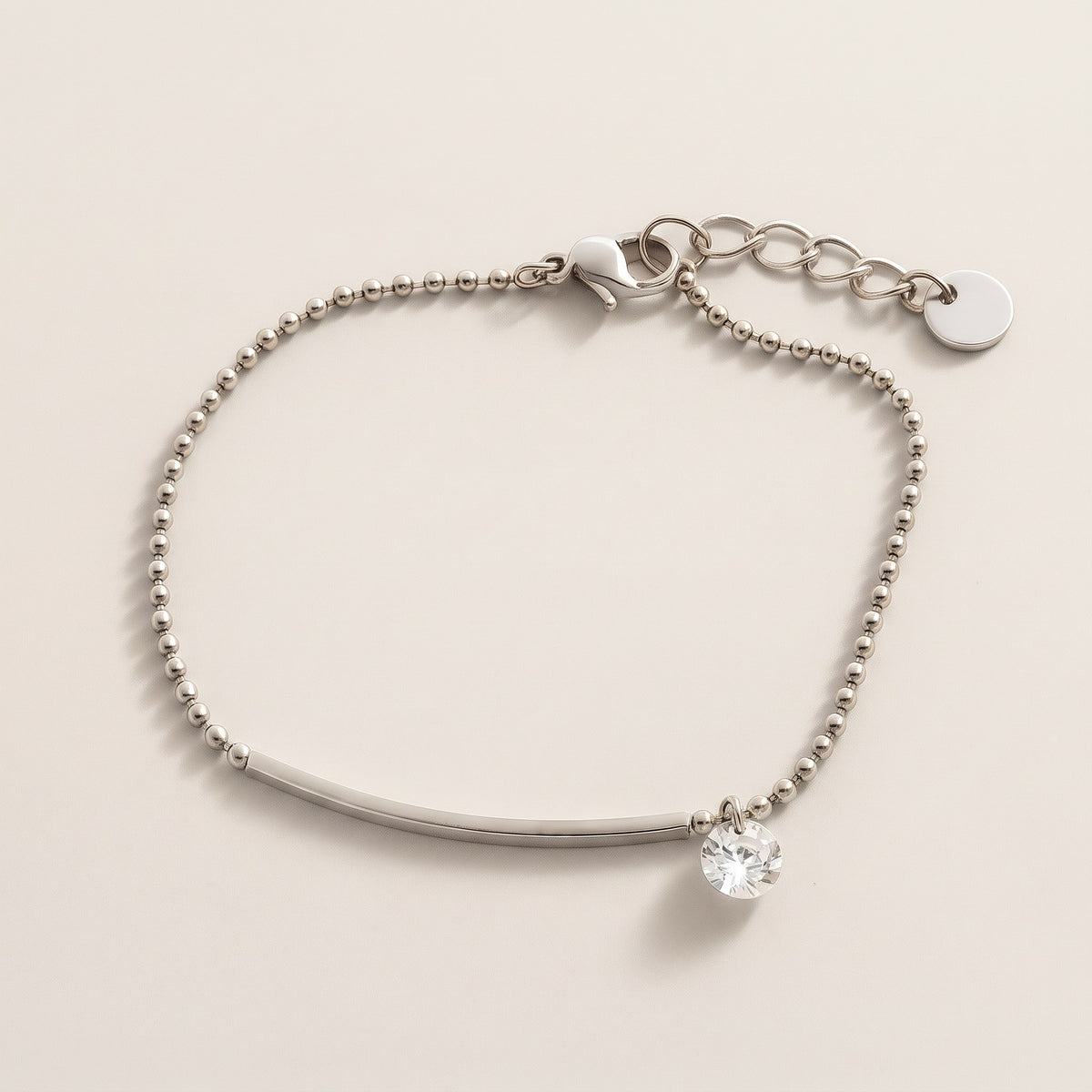 Eos Bracelet in gold, ball chain with a slim bar and one clear crystal