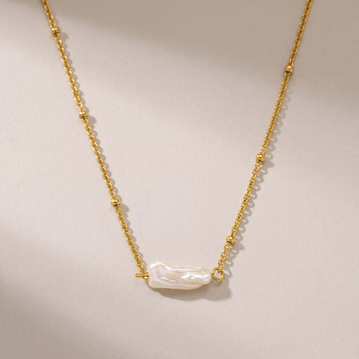 Helios Pearl Necklace in gold with a single baroque freshwater pearl