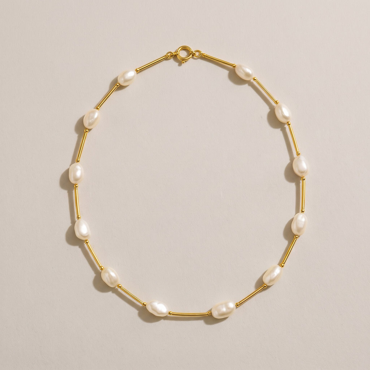 Maldives Necklace in gold with small oval freshwater pearls between gold bars