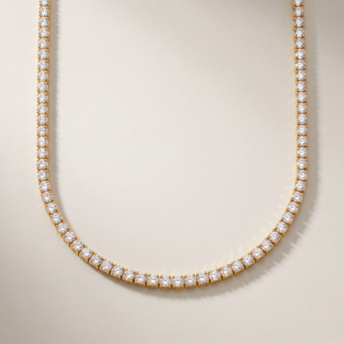 Monaco Tennis Necklace in gold, a single row of round clear stones