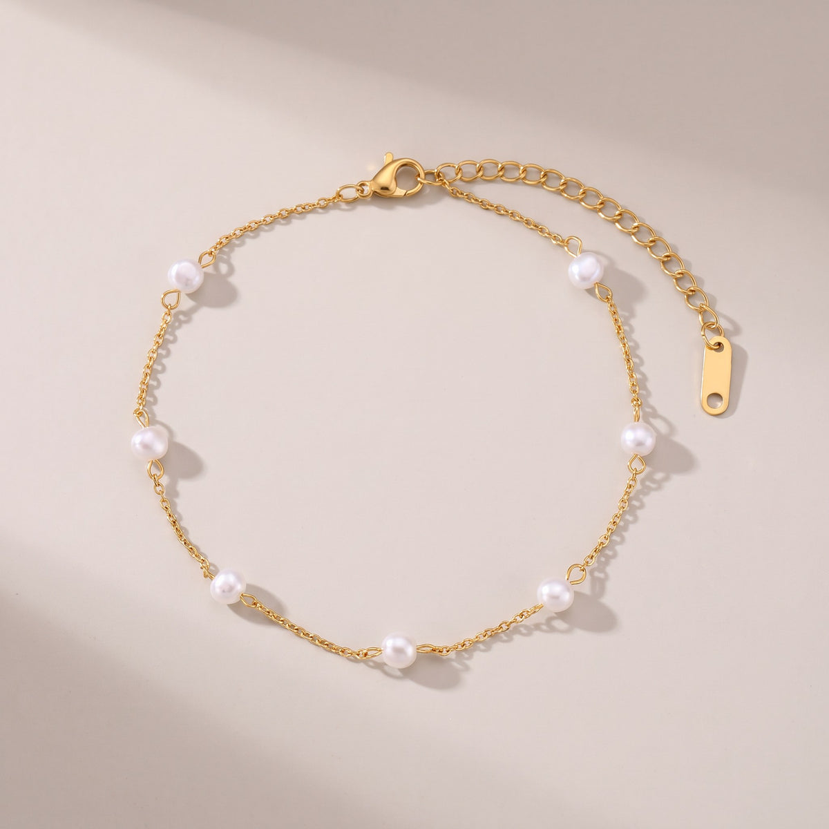 Cali Pearl Anklet in gold with small white pearls, laid flat