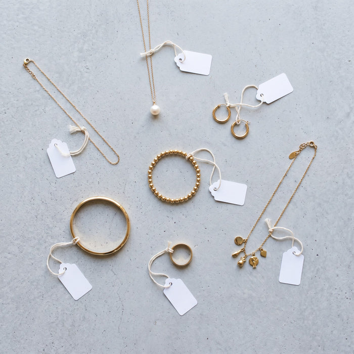 Single gold jewelry pieces each with its own price tag